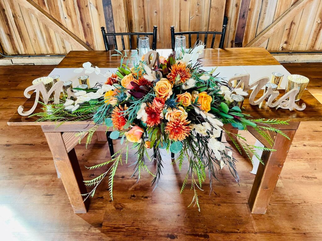 fall flowers on sweetheart table